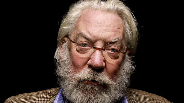 Donald Sutherland looking directly into the camera lens with a bushy beard and mustache